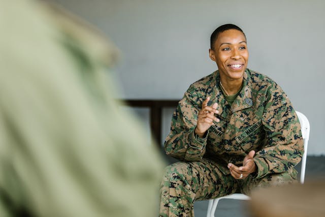 A uniformed woman smiling and talking